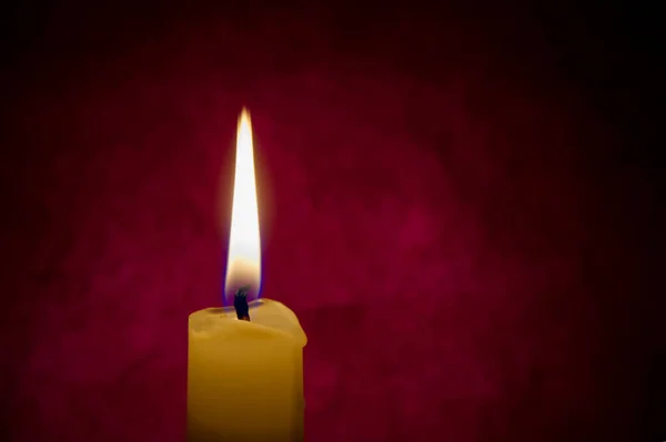 Single Red Candle Burning Alone Dark Red Background Conceptual Image — 스톡 사진
