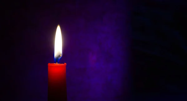 Single Red Candle Burning Alone Dark Blue Background Conceptual Image — 图库照片