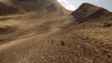 FPV insansız hava aracı görüntüleri: Düzleştirilmiş Sinek Highland Gölü etrafındaki Rocky Tepesi boyunca uçuyor.