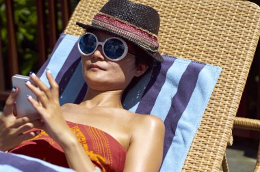 Genç kadın güneşleniyor.