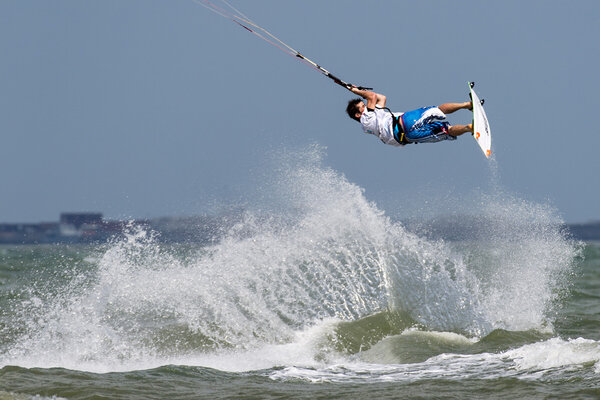 Kitesurfing trick with big sea spray