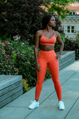 Beautiful young woman runner standing outdoor in sport outfit 
