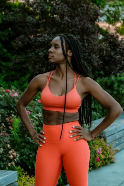 Beautiful young woman runner standing outdoor in sport outfit 