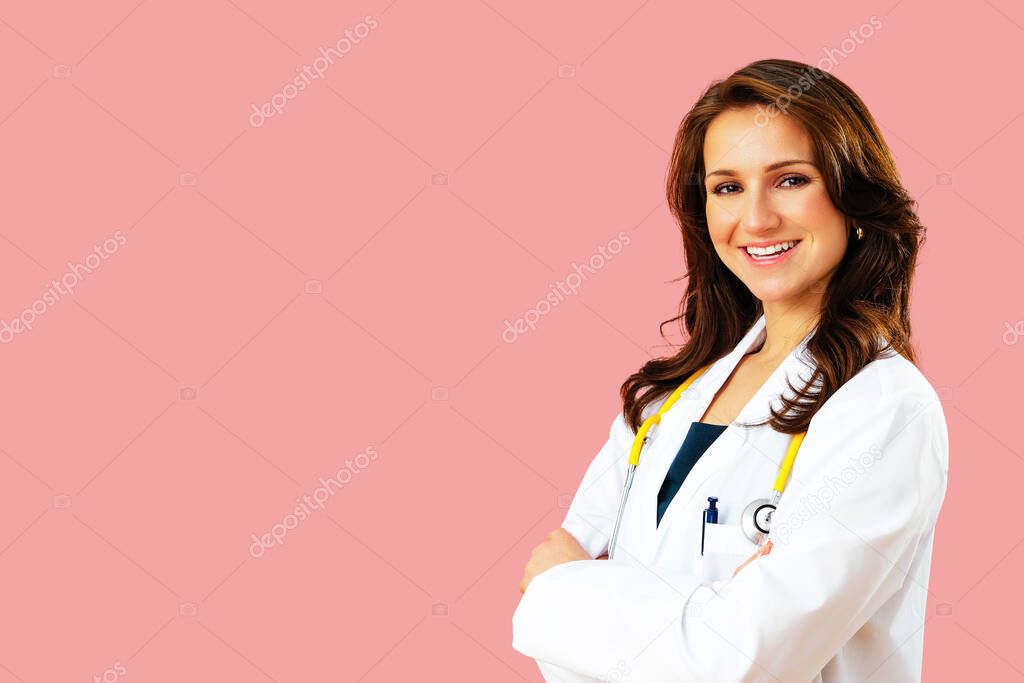 Portrait of smiling female doctor with arms crossed on pink studio background  