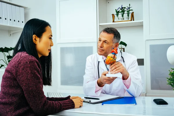 Médico Sorrindo Mostrando Mockup Coração Humano Para Sua Paciente Sexo — Fotografia de Stock