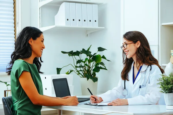 young female doctor smiling with woman patient consultation clinic health checkup