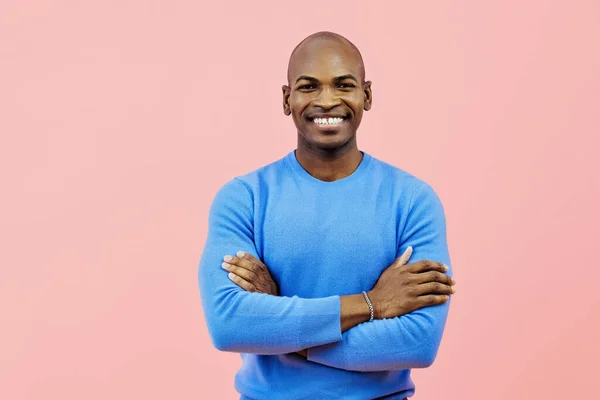 man smiling with folded arms indoors studio