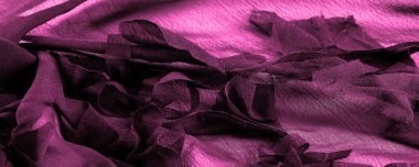 Doku. Arka plan kırmızı bordo ipek kumaş, üst manzara. Kırmızı ipeğin ya da satenin pürüzsüz dokusu, kopyalama alanı olan soyut bir arkaplan olarak kullanılabilir.