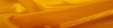 Sarı ipek kumaş. Doku. Geçmişi. Şablon. Bu kumaş mükemmel. Dokunmak için çok güzel, parlak ama çok parlak değil ve çok güzel bir rengi var.