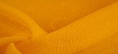 Sarı ipek kumaş. Doku. Geçmişi. Şablon. Bu kumaş mükemmel. Dokunmak için çok güzel, parlak ama çok parlak değil ve çok güzel bir rengi var.