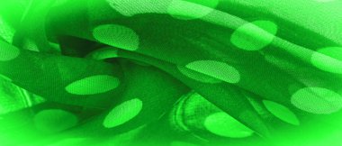 Puantiyeli yeşil ipek kumaş, bir daireye benzeyen veya kabaca bir daireye benzeyen kumaş üzerinde dairesel noktalar. Arkaplan dokusu, dekoratif süs