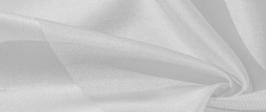 İpek beyazdır. Beyaz gri saten doku, gümüş kumaş, ipek panorama, arka plan, güzel yumuşak bulanık desenli. Doku, arkaplan deseni
