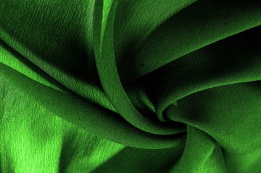 Doku. Geçmişi. Geçmişi. Koyu yeşil, parlak kumaş dokusu, bu soyut bir ipek kumaş arkaplanı.