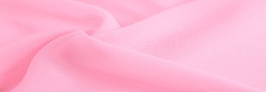 İpek kırmızı polyester. Pembe ipek kumaşın arka planı. Şeffaf arkaplan ve elbise dikmek için açık kumaştan yapılmış. Tekstil panoraması. Dokuma. şablon.