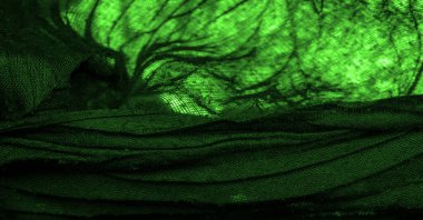 Doku. Geçmişi. Geçmişi. Koyu yeşil, parlak kumaş dokusu, bu soyut bir ipek kumaş arkaplanı.