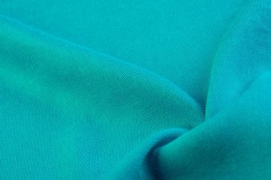 Turkuaz kumaş, kumaş. Çapraz iplik dokuması olan ince kumaş. Latince ve Fransızca 'dan, materyalin adı transla doku, arka plan