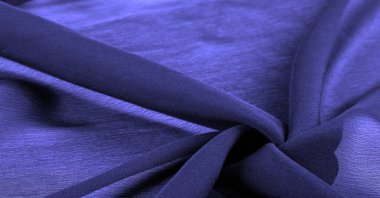 Doku. Geçmişi. Geçmişi. Koyu mavi kumaş dokusu parlak, soyut bir ipek kumaş arkaplanı..