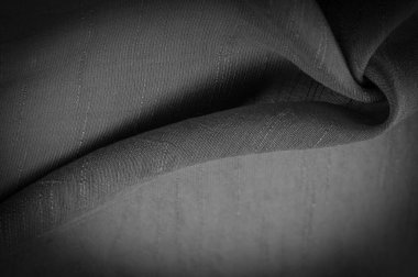 Siyah kumaş, koyu siyah ipek, dokuma kumaş arkaplan. Dekoratif eşyalar yakın plan. Duvar kağıdı dokusu, arkaplan