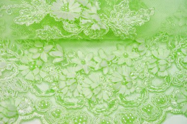Dantel yumuşak yeşil. Doku. Geçmişi. şablon. Soluk yeşil çubuklu, eski dantelli ve salata sıralı soyut bir arka plan. Kartpostal, poster, doku veya duvar kağıdı olarak kullanılabilir