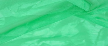 Yeşil ipek kumaş, zümrüt ipekten soyut arkaplan. Kumaşlı kumaş. Uzayı kopyala Tasarım elemanı. Sevgililer Günü. Doku deseni, süs, arkaplan
