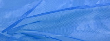 Mavi ipek kumaş, gök mavisi ipekten soyut bir arkaplan. Kumaşlı kumaş. Uzayı kopyala Tasarım elemanı. Sevgililer Günü. Doku deseni, süs, arkaplan