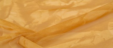 Sarı ipek kumaş, soyut kehribar ipek arka plan. Kumaşlı kumaş. Uzayı kopyala Tasarım elemanı. Sevgililer Günü. Doku deseni, süs, arkaplan