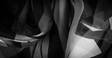 Siyah ve beyazın soyut tonlarında ipek kumaş. İpek doku, soyutlama için lüks saten, tasarım ve duvar kağıdı, doku. Şablon. şablon.