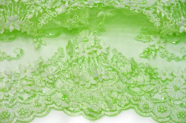 Dantel yumuşak yeşil. Doku. Geçmişi. şablon. Soluk yeşil çubuklu, eski dantelli ve salata sıralı soyut bir arka plan. Kartpostal, poster, doku veya duvar kağıdı olarak kullanılabilir