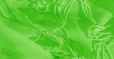 Yeşil ipek kumaşın parlak bir parlaklığı var. Bu çok yönlü bir kumaş. Tasarımının güzel aksanlarıyla yaratıcı ol. arkaplan