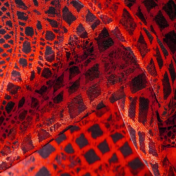 Tekstil malzemesinden kırmızı arka plan. dantel kumaş. Doğal yakut dokusu. Doku, arkaplan, desen.