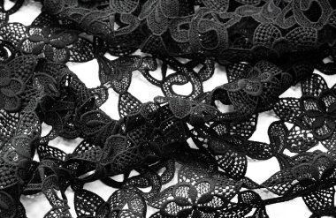 Siyah dantelli kumaş. Çiçek desenli saf pamuk dantel nakışla süslenmiş. Işık Şeffaflığı. Kalıplı. Geçmişi. Desen