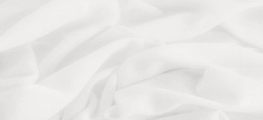 Beyaz kumaş. Lüks kumaşın soyut arka planı ya da dalgaların sıvı ipek dokusu ya da dalgalı kıvrımlar. arka plan ya da zarif duvar kağıdı tasarımı. Pamuk dokusu, doğal kumaş ve boya.