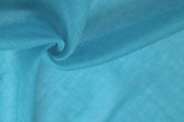 Mavili ipek kumaş. Pürüzsüz mavi ipek ya da lüks saten kumaş dokusu soyut bir arkaplan olarak kullanılabilir. Lüks Noel arkaplanı