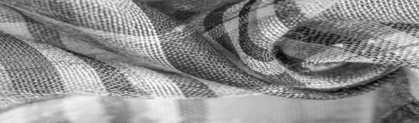 İskoç dokusunun arka plan dokusu, ki bu dokunun adı doğrudan ülkenin kökenini gösterir. Bu materyalin ikinci ve daha doğru adı tartan..