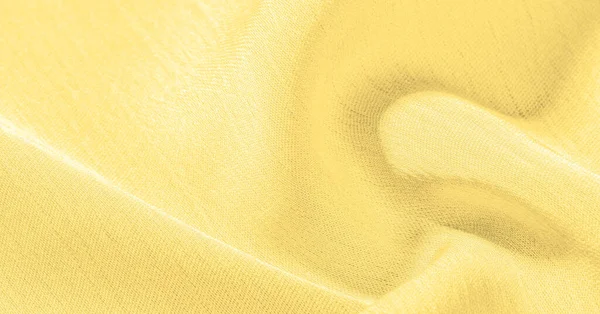 Sarı ipek kumaş. Pürüzsüz bir bitişi var. Tasarımdan projelerinize kadar her şey için bu lüks kumaşı kullanın. Arkaplan, desen, doku