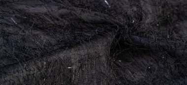 Kumaşın yüzeyinde pullu ve iplikli kömür siyah ipek kumaş. Bu ombre tülleri soyut işlemelerle süslenmiş, bir Avrupalı tasarımcının pulları ve iplikleriyle süslenmiş.