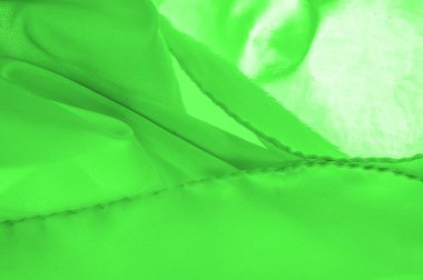 Yeşil ipek kumaş, zarif, dalgalı, yeşil saten ipek lüks kumaş, soyut tasarım. arkaplan dokusu, desen