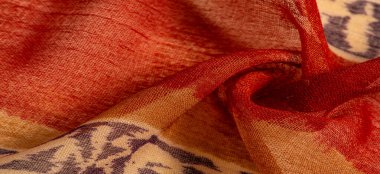 Kumaştaki soyut desen, büyük örgülü iplik, kırmızı-sarı bej desenli çizgiler, projeleriniz için bu kumaş. Doku