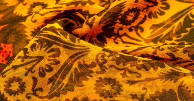 Çiçek desenli ve eşkenar dörtgenli ipek kahverengi. Yumuşak kumaş, parlak doku arka plan, saten arka plan, kumaş lüks iş, zarif desen, renkli soyut, renkli kadife, makro dilimlenmiş.