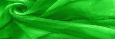 Yeşil arka planda gri lekeli yeşil kumaş. Soyut tasarımcı kumaş tasarımcısı. Tasarımın için güzel bir arka plan. Doku. Görüntü. çizim, kalıp, şekil