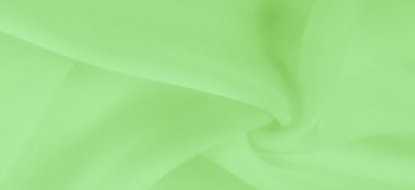 Açık yeşil ipek polyester. Kireç yeşili ipek kumaştan. Şeffaf arkaplan ve elbise dikmek için açık kumaştan yapılmış. Tekstil panoraması