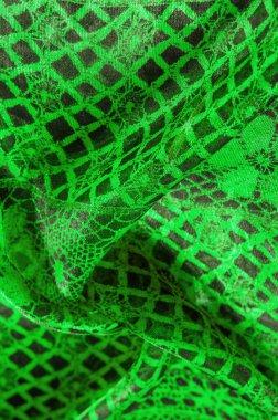 Tekstil malzemesinden yeşil arkaplan. dantel kumaş. Doğal zümrüt dokusu. Doku, arkaplan, desen.