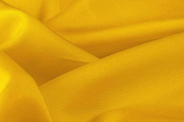 Sarı ipek kumaş, zarif, zarif, sarı saten, lüks kumaş, soyut tasarım. arkaplan dokusu, desen
