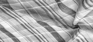 İskoç dokusunun arka plan dokusu, ki bu dokunun adı doğrudan ülkenin kökenini gösterir. Bu materyalin ikinci ve daha doğru adı tartan..