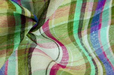 İskoç dokusunun arka plan dokusu, ki bu dokunun adı doğrudan ülkenin kökenini gösterir. Bu materyalin ikinci ve daha doğru adı tartan..