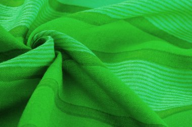 Tayftaki mavi ve sarı arasındaki rengin yeşil, çimen ya da zümrüt renginde ipek kumaş. Doku. Arkaplan.