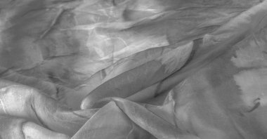 Beyaz arka planda gri benekli siyah beyaz kumaş. Soyut tasarımcı kumaş tasarımcısı. Tasarımın için güzel bir arka plan. Doku. Görüntü. çizim, kalıp, şekil