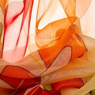 red, white and yellow geometric colors, made of fine viscose silk. organza pattern. Texture. Background fine knitted fabric - light transparent,