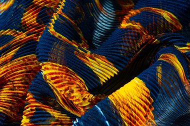 silk crimped. Blue, yellow, brown, burgundy colors. Ruffled silk fabric in vintage style. Floral pattern for elasticity. Opens the gathered fabric into pleasing and flattering folds.