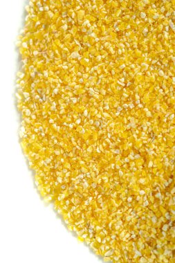 Corn grits. Grits are cooked cornmeal porridge. Gominy cereals are a type of cereal made from mother's corn. Grocery photography